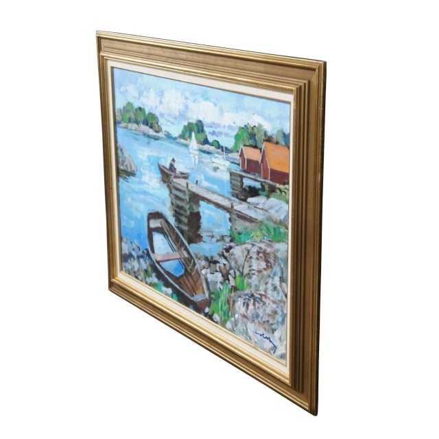 An impressionist painting from the last half of the 20th century. Features a port side view with boats and houses on the...
