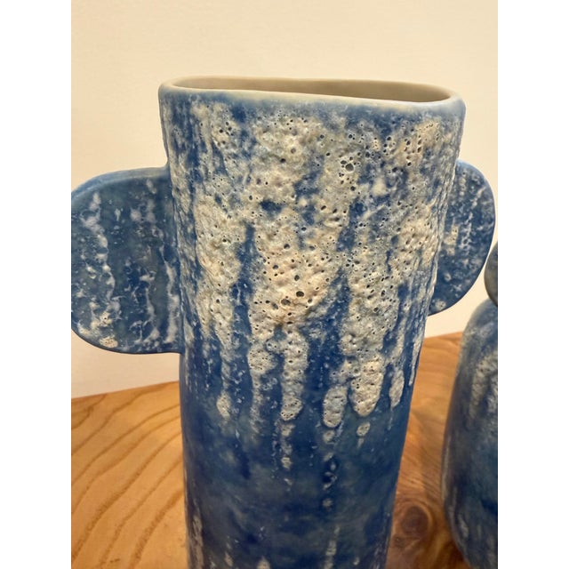 The Paros Blue Vase Set has a Mediterranean feel, thanks to the reactive glaze on the blue ceramic vases. The texture...