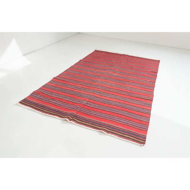 This is a vintage Turkish Oushak rug from the Mid 20th Century. The piece was hand-knotted.