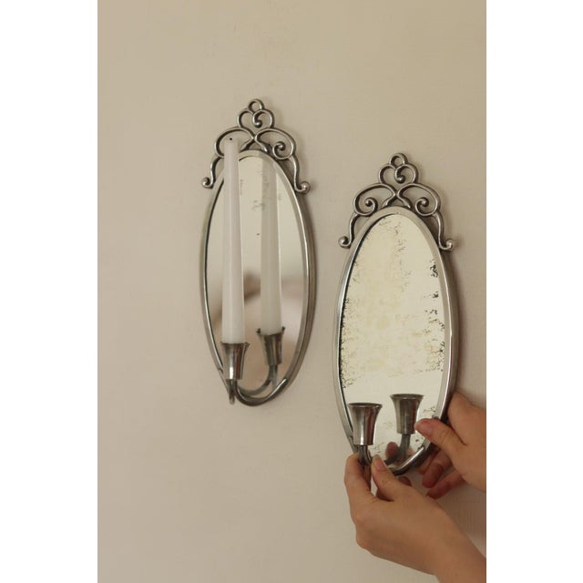 Pair of Mid Century Swedish Pewter Sconces by Svenskt Tenn These are pewter mirror wall sconces by Svenskt Tenn, featuring...