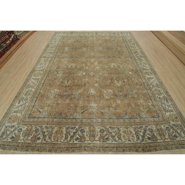 An authentic vintage traditional Tabriz rug hand-knotted with an all-wool pile on a cotton foundation. This oriental rug...