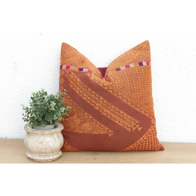 This 18-inch square pillow is a luminous example of Antique Phulkari craftsmanship, repurposed from a single, 19th-century...