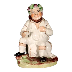 Staffordshire Pottery Figure of Bacchus With Cup on a Wine Barrel