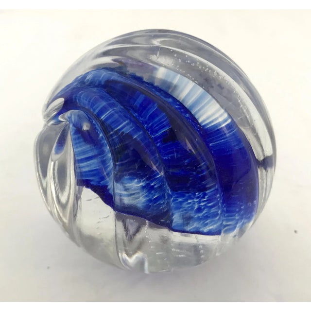 Vintage art glass paperweight with scalloped exterior and blue decoration within the glass / Made in USA in 2000 Measures:...