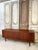 Scandinavian teak sideboard attributed to Svend Aage Larsen, circa 1960. The sliding doors feature handles carved into the...