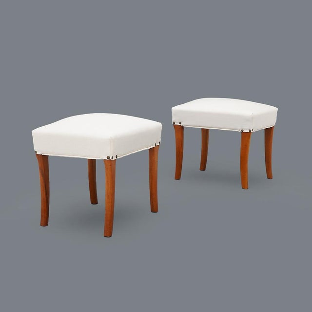 Pair of Italian manufacturing stools produced in the 1950s. Padded wood seat and lined in white fabric. Curved and shaped...
