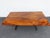 This striking dining table is crafted from solid mahogany and metal, featuring a contemporary modern design with a long,...