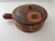 This is a vintage Mexican Tlaquepaque redware pottery lidded bean pot featuring a hand-painted floral motif with a side...
