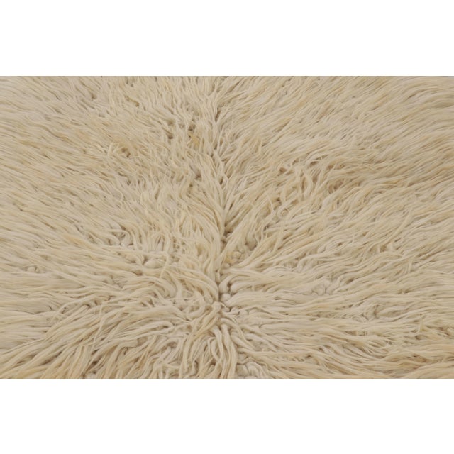 Made with hand-knotted high-pile wool in Turkey, this 5x7 vintage Tulu rug is a distinguished addition to Rug & Kilim’s...