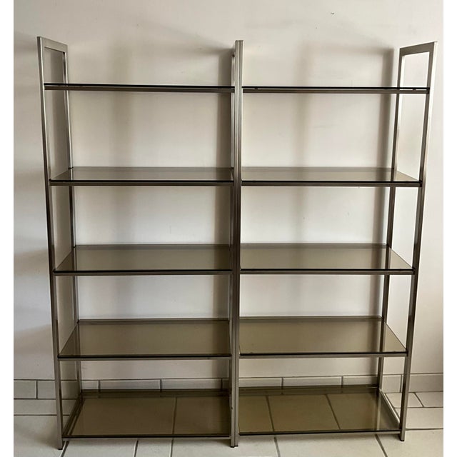Elegant pair of French shelving units attributed to Artelano, dating from the 1970s. Featuring satin-finished anodized...