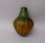 Italian ceramic vase by Marcello Fantoni. Green and mustard glaze on bulbous form.