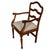 A handsome 19th-century mahogany armchair featuring a shaped ladderback and gently scrolled crest rail. The warm, richly...