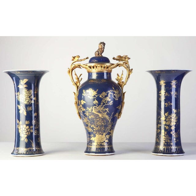 A set of three 18th century, Chinese powder-blue gilt-decorated vases. Each painted with composite floral patterns, the...