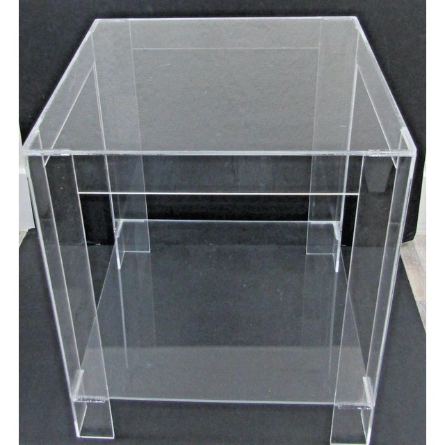 The MCM Hollywood Regency Clear Lucite Acrylic Two-Tier Square Side Table is a vintage piece of furniture that exudes...