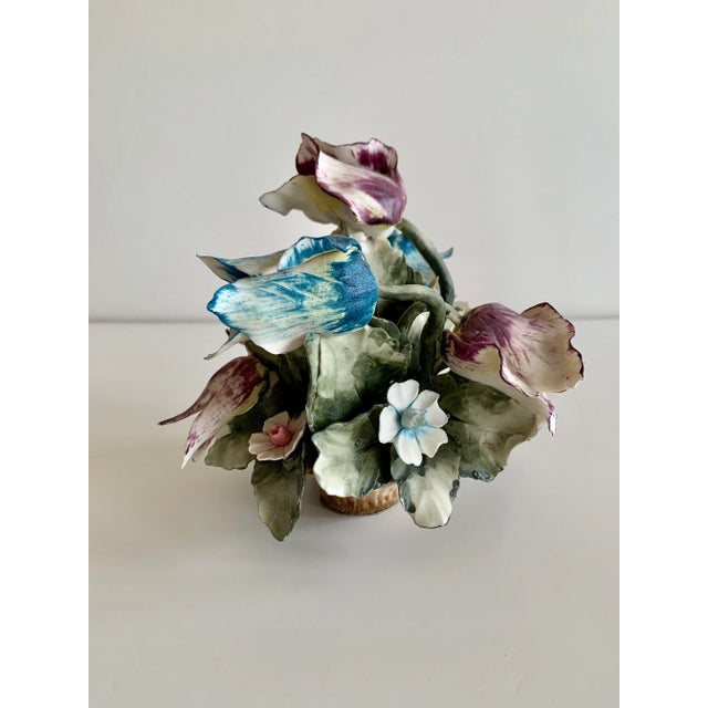 Wonderful large vintage porcelain piece. A porcelain basket over flowing with porcelain flowers, purple and blue tulips,...