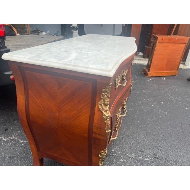 This exquisite commode is a fine example of Italian artistry. Crafted from rich mahogany and adorned with beautiful...