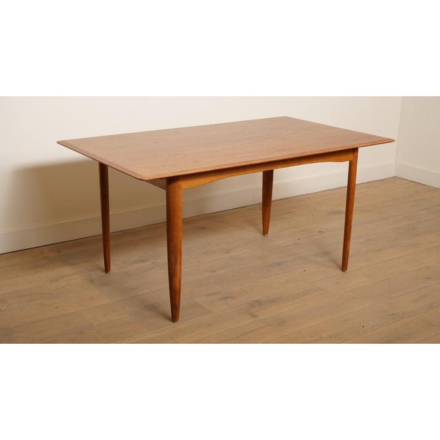 This beautiful vintage extendable dining table has a sleek design and is incredibly functional. The teak dining table has...