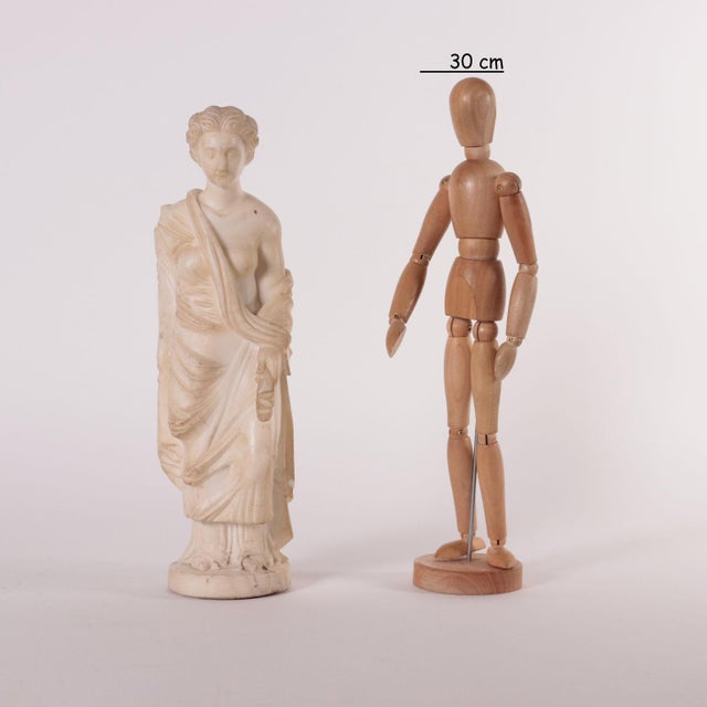 19th Century marble sculpture representing a roman matron the figure stands on the left leg and is wearing a long robe...