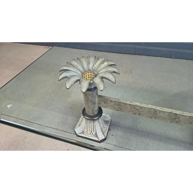 Vintage coffee table with a clear glass top and a cast iron flower base. Hollywood regency style. Good condition, nice...