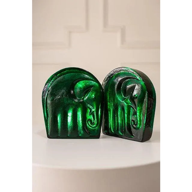 These stunning emerald glass bookends by Joel Myers for Blenko, c.1960s, USA, resemble sculpted ice, thick, glossy, and...