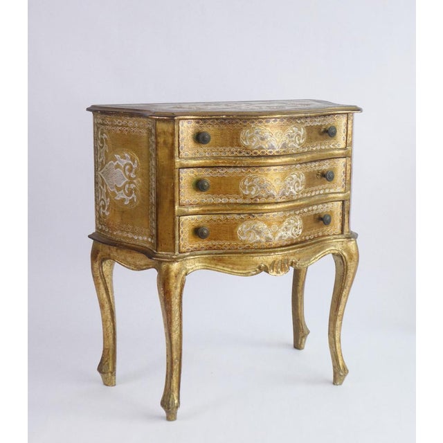 Vintage Florentine chest of drawers with unique gold and white painted details. The cabinet has three drawers with brass...