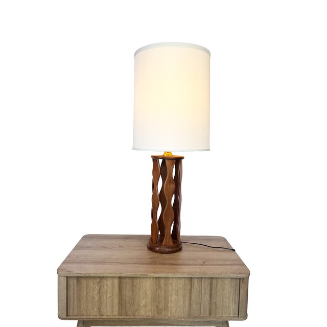 This sculptural Mid-Century Modern table lamp is a stunning example of Modeline-era design. It features a carved wavy...