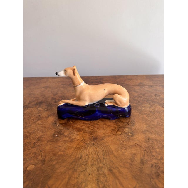 Quality antique Victorian Staffordshire Greyhound inkwell, having a greyhound laying on a shaped blue coloured base, hand...