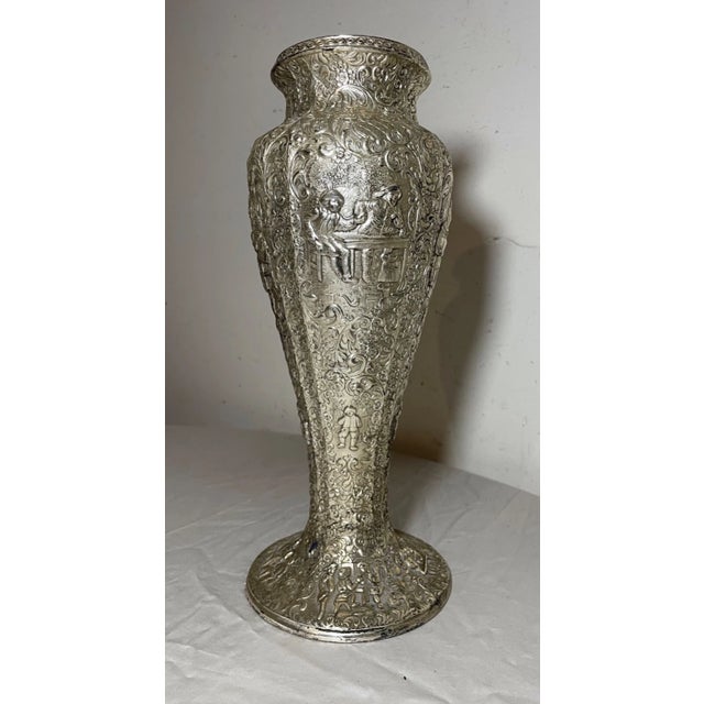 This exquisite vase is a stunning piece of antique Dutch artistry. The intricate silverplate composition features a...