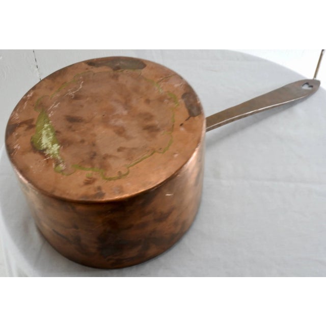 A French, large copper stock pan. Hand-forged with dove tailing. Very heavy with a nice aged patina. Handle has a cut-out...