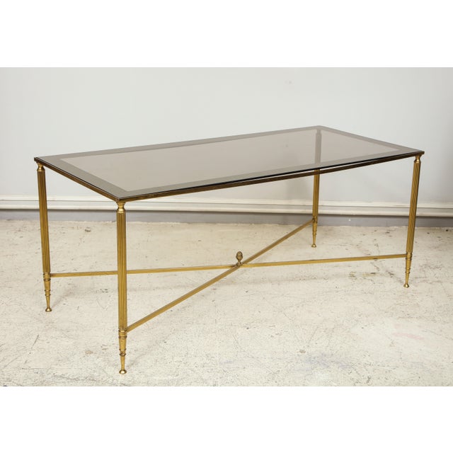 Rectangular brass coffee table with smoked glass.