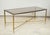 Rectangular brass coffee table with smoked glass.