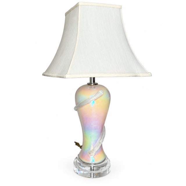 Bring a luminous, sculptural accent to your space with this pearlescent table lamp. Its graceful, rounded body narrows at...