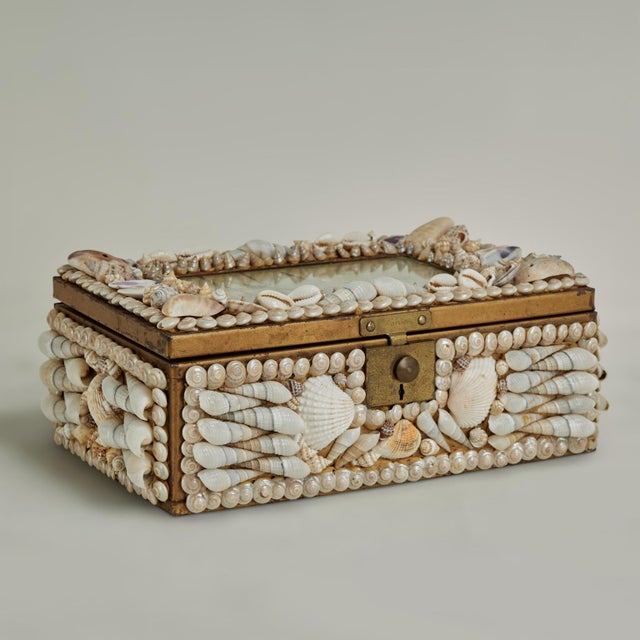 Enchanting sailors valentine box crafted in wood and brass and encrusted with exotic seashells around an image of a...