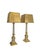 A pair of impressive neoclassical table lamps, painted in white and gold, in the louis xvi style. the lamp bases feature...
