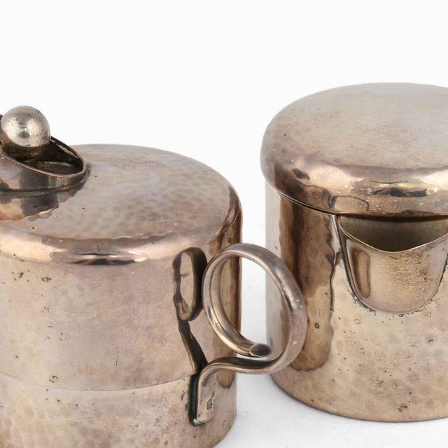 Two vintage pitchers is an original decorative pair of objects realized in the early 20th century. Original silver plated...