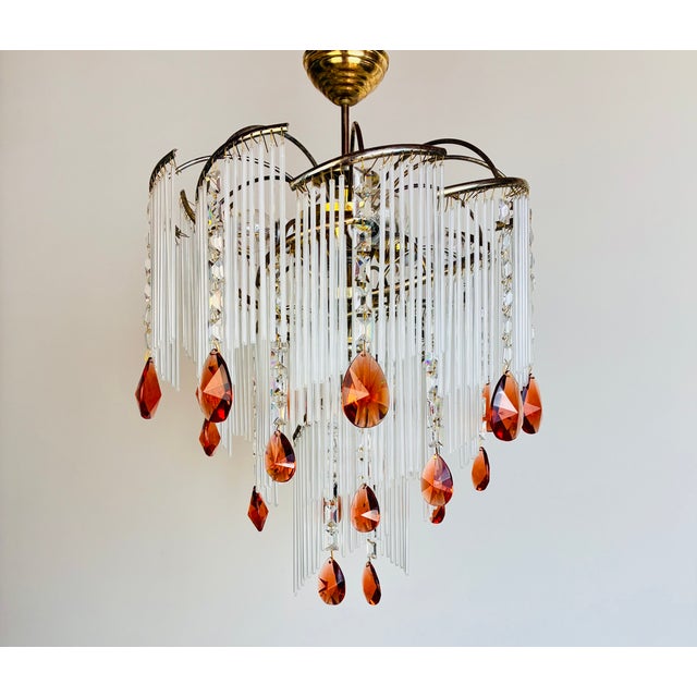 Vintage 1980s milk glass chandelier redesigned with amber crystal drops and clear crystals. The brass structure shows...
