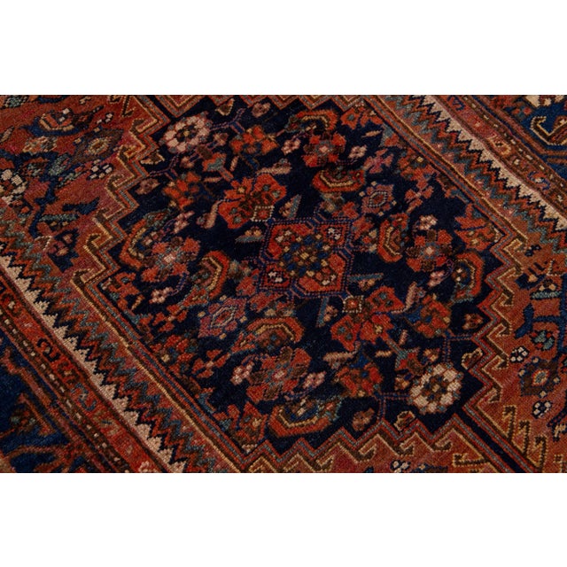 Beautiful vintage Persian Hamadan hand-knotted wool rug with a navy blue field. This piece has a blue frame and multicolor...