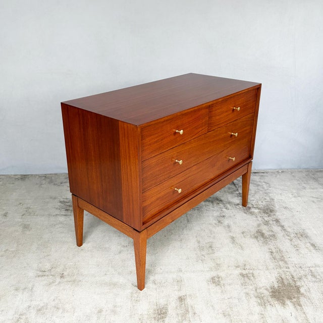 Four drawers arranged as two short drawers across the top and two full-width drawers beneath, set within a shallow...