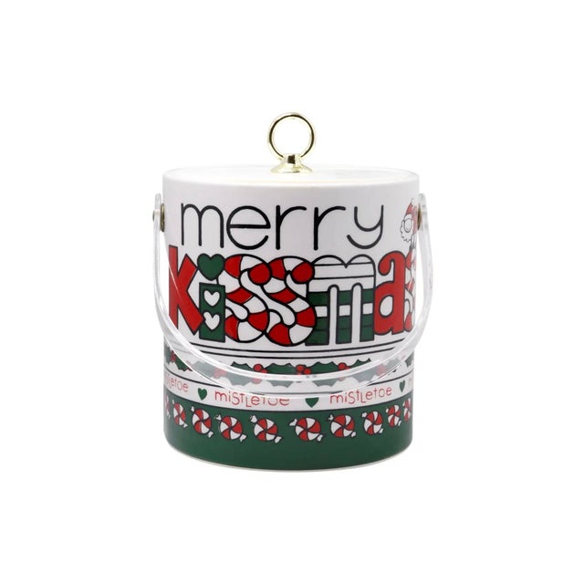 A festive Christmas themed ice bucket by Cora, in red, white and green. The lid is white and lifts off with a gold tone...