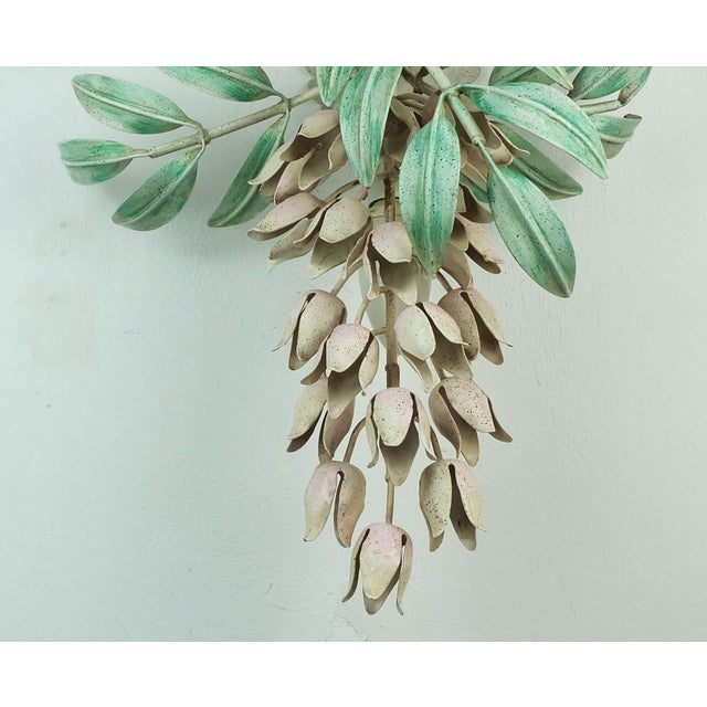 A beautiful and decorative Florentine wall lamp made of metal. Stylized wisteria vine in shades of pink and green. For an...