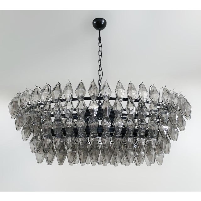 Italian oval shaped chandelier with smoky polyhedron / polyhedral shaped Murano glasses mounted on matte black powder...