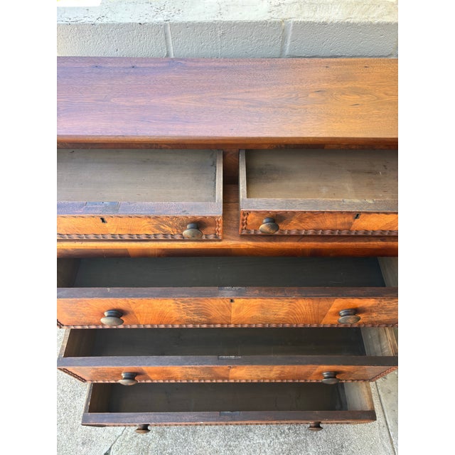 Antique Victorian late 19th century stepback dresser / chest of drawers on casters with bookmatched veneer drawer faces...