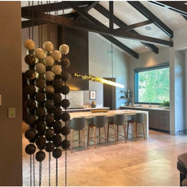 This unique sculpture by Kelly Farley features rows of anagama fired ceramic spheres in neutral tones, connected by sturdy...