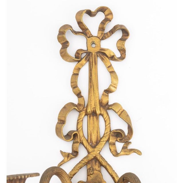 Pair of Louis XVI Style Gilt Metal Ribbon Appliques, with flower basket motif. 16.75" H x 8" W x 5.5" D. Provenance: From...