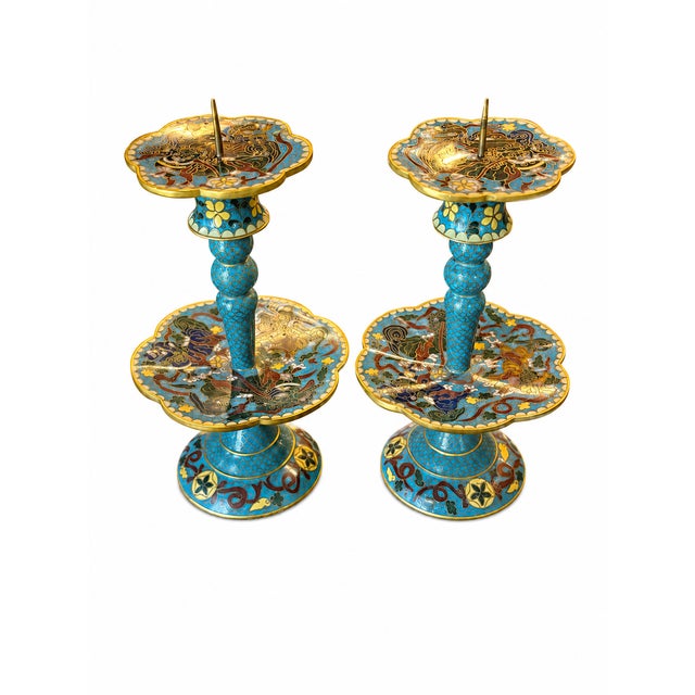 Striking pair of vintage Chinese cloisonné enamel candlesticks featuring intricate dragon and cloud motifs in rich shades...