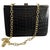 This is an elegant Italian shoulder bag from the 1950s, showcasing a luxurious combination of black leather and brass...