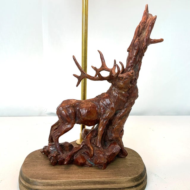 Bring a touch of nature-inspired elegance to your home with this unique table lamp featuring a hand-carved stag sculpture...