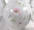 This is a smaller white shaped tea pot or coffee pot marked the Winrose Collection and Hand Decorated in USA. I don’t know...