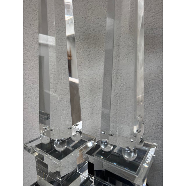 An impressive pair of monumental optical crystal obelisks, each rising from four polished crystal sphere supports atop a...
