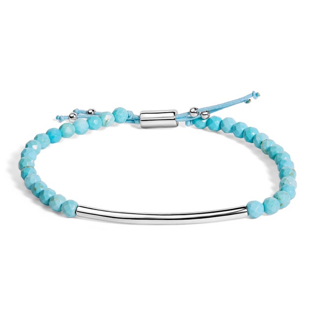 Adorn your wrist with the mesmerizing allure of this sterling silver bracelet, elegantly punctuated by polished turquoise...